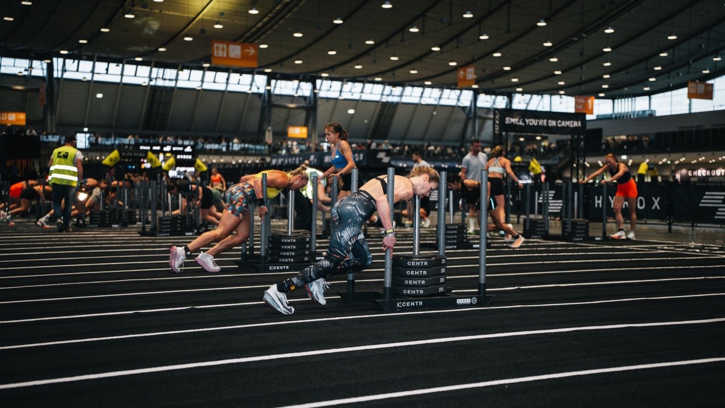 Athletes on the sled push at a HYROX race
